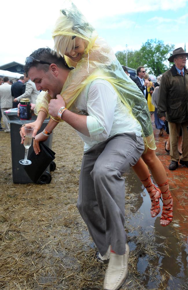 Thankfully this highheeled racegoer had a knight in shining armour in her midst. Picture: Craig Borrow/News Corp Australia