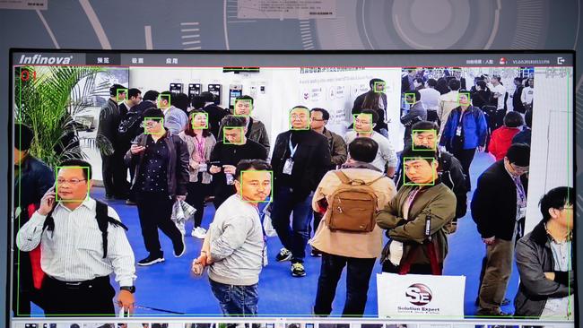 A screen shows visitors being filmed by AI (Artificial Inteligence) security cameras with facial recognition technology at the 14th China International Exhibition on Public Safety and Security at the China International Exhibition Center in Beijing (Photo by NICOLAS ASFOURI / AFP)