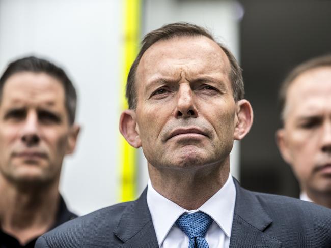 Different focus ... Roman Roman Quaedvlieg from the Australian Border Force, Australian Prime Minister Tony Abbott and Federal Minister for Immigration Peter Dutton speak to media after visiting an airport cargo screening operation at the DHL Processing Facility at Brisbane Airport yesterday: Source: AAP