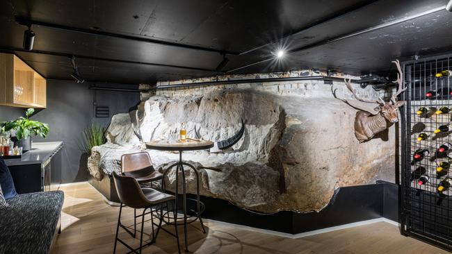 The wine cellar of 12 Tobruk Ave, Cremorne, is built to accommodate an existing piece of sandstone.