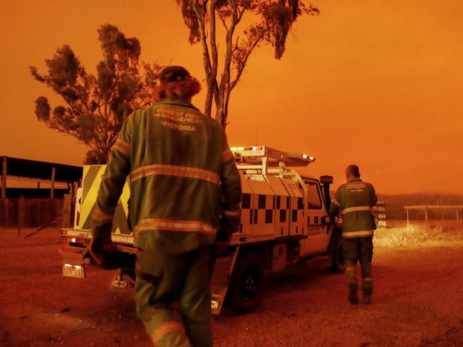 EAST GIPPSLAND, AUSTRALIA - JANUARY 04: Department of Environment, Land, Water and Planning crew get into their vehicle to respond to a call on January 04, 2020 in Double Bridges, Australia. Two people are dead and 28 remain missing following bushfires across the East Gippsland area, with Victorian premier Daniel Andrews declaring a state of disaster in the region. Thousands of people remain stranded in the coastal town of Mallacoota and are being evacuated by navy ships to Melbourne. (Photo by Darrian Traynor/Getty Images)