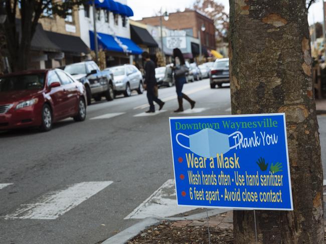 Signage advising people of precautions to stop the spread of Covid-19 is displayed on the main street of Waynesville, North Carolina. Picture: Angus Mordant