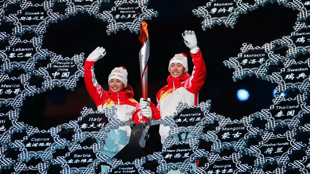 Torch bearers Dinigeer Yilamujiang L and Zhao Jiawen. Photo by Liu Xu/Xinhua via Getty Images