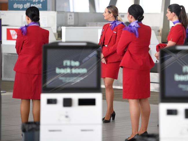 Virgin Australia employees are seen at Sydney Airport, in Sydney, Tuesday, April 21, 2020. Virgin confirmed it had gone into administration on Tuesday, threatening up to 10,000 airline jobs after a board meeting of its international shareholders voted on Monday against providing additional financial support. (AAP Image/Dan Himbrechts) NO ARCHIVING