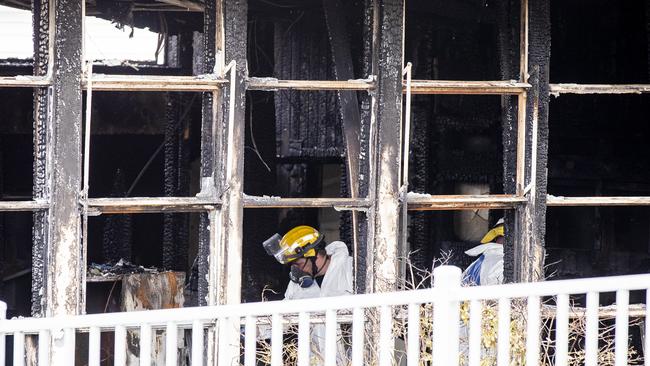 Police and fire investigators at the site of the overnight fire at Cosgrove High School. Picture: RICHARD JUPE