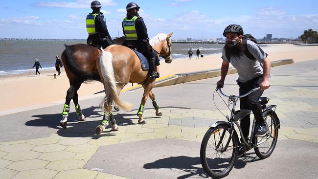 Police patrol along the St Kilda Esplanade in Melbourne on Monday. Picture: AFP