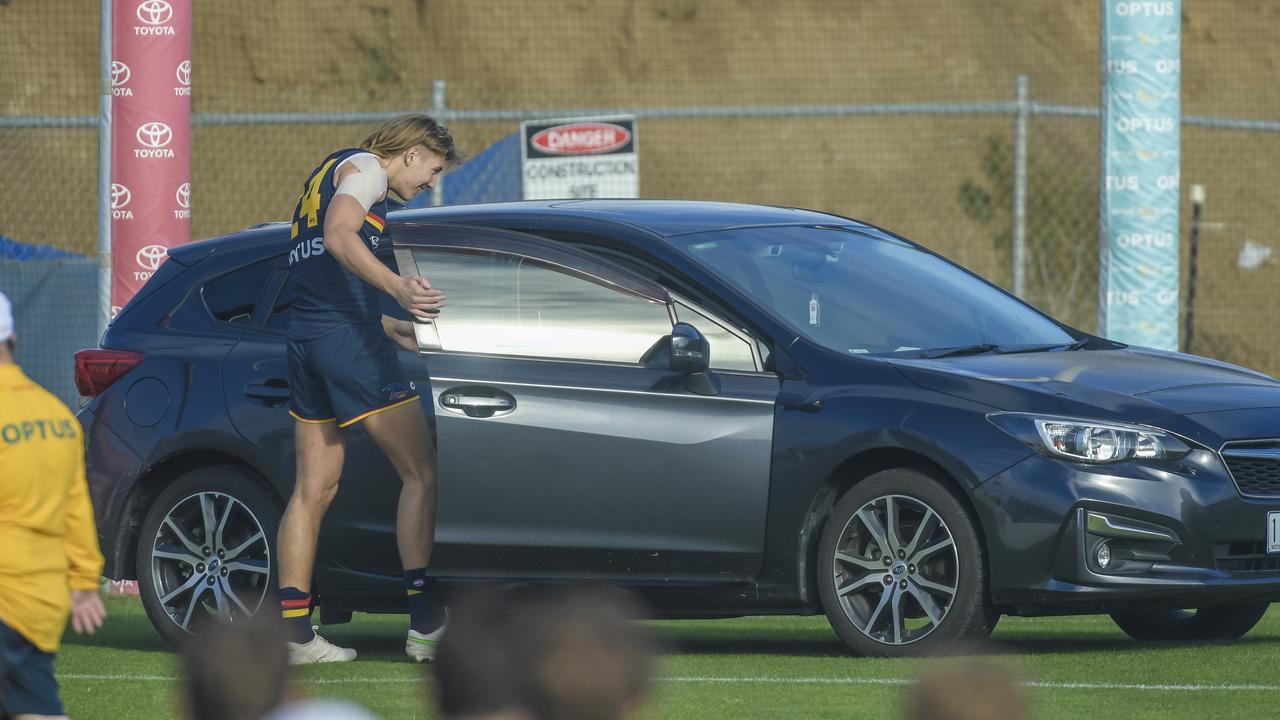 Worrell retrieves his car as his teammates watch on. Picture: Roy VanDerVegt