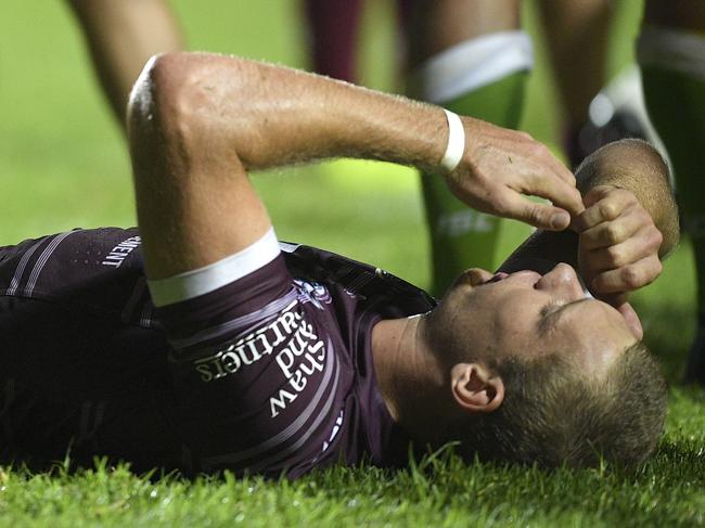 Tom Trbojevic of the Sea Eagles receives attention from a  trainer after sustaining and injury during the Round 4 NRL match between the Manly-Warringah Sea Eagles and the Canberra Raiders at Lottoland in Sydney, Saturday, March 31, 2018. (AAP Image/Dan Himbrechts) NO ARCHIVING, EDITORIAL USE ONLY