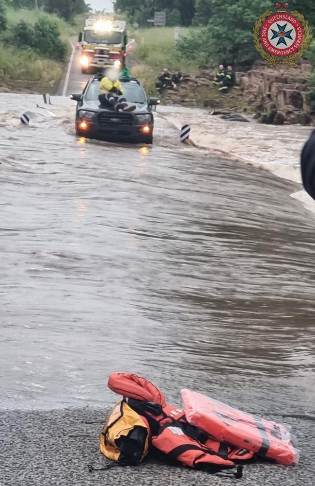 A 48 year old man took refuge on his car bonnet after being inundated by floodwaters outside Nebo. Photo: QFES