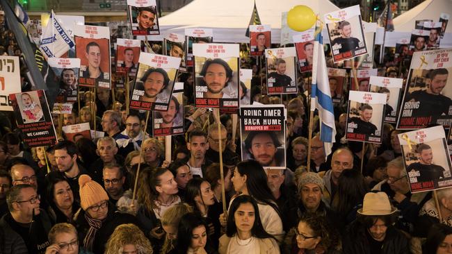 People hold photos of hostages during a Tel Aviv rally to mark their 100 days of captivity in Gaza. Picture: Getty Images