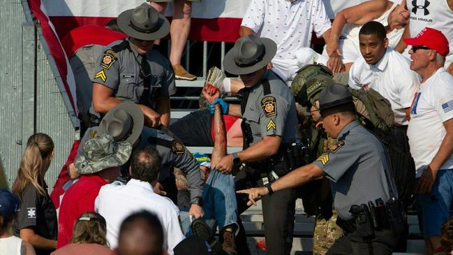 A person is removed by state police from the stands. Picture: AFP