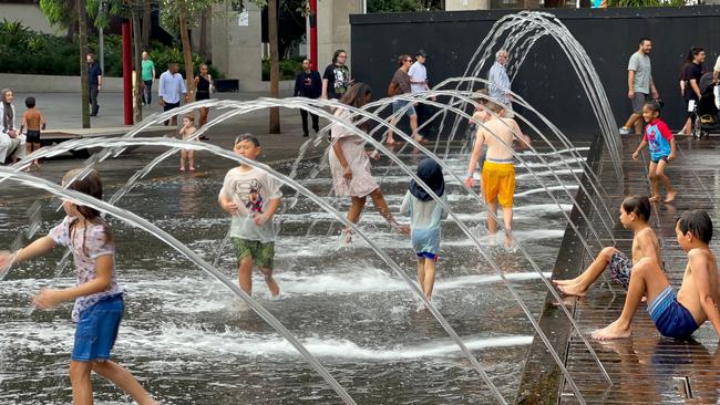 Kids splashing in the water fountains at Sydney's Darling Harbour. Picture: Linda Smith