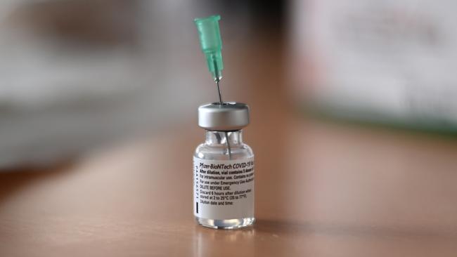 An injection needle sits in a containing the Pfizer-BioNTech COVID-19 vaccine. Picture: Ina Fassbender/AFP