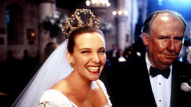 Toni Collette as Muriel Heslop and Bill Hunter as her father Bill in the 1994 film version of Muriel’s Wedding.