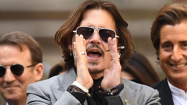 Depp gestures to supporters as he leaves court after the final day of his libel trial. Picture: Daniel Leal-Olivas/AFP