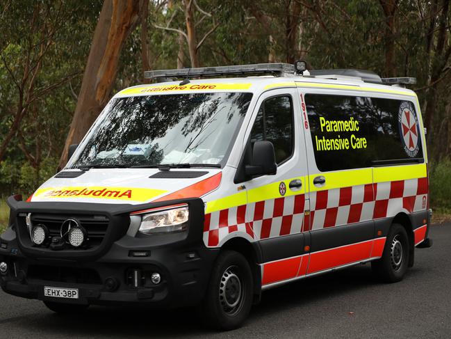 SYDNEY, AUSTRALIA - NewsWire Photos JANUARY 20, 2021: An ambulance passes by a police road block near Keith Longhurst Reserve near where a police search is underway on the Georges river for a 15-year-old teenage boy believed to have drowned while swimming.Picture: NCA NewsWire / Damian Shaw