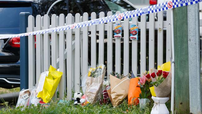 Mourners bring tributes to lay at the gates to the Faulconbridge home. Picture: Max Mason-Hubers