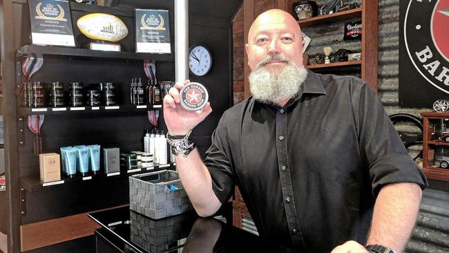 SLEEK LOOK: Barber shop owner Rex Silver with his matte paste which is nominated for best male styling product of the year in the Australian Hair Industry Awards. The paste is one  of 10 products in Mr Silver's range. Picture: Noor Gillani