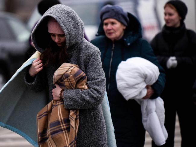 Ukrainian evacuees walk at the Ukrainian-Romanian border in Siret, northern Romania. Picture: AFP