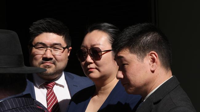 Jie Shao (centre) is facing manslaughter charges over the death of Ms Huang. Picture: Damian Shaw