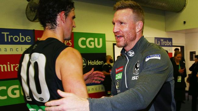 Nathan Buckley celebrates Collingwood’s Round 10 win with Scott Pendlebury.