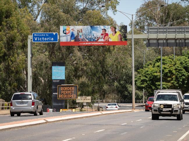 Albury NSW, AUSTRALIA - Herald Sun - December 20th, 2020:A permit system will be introduced from midnight for all NSW residents travelling to Victoria as Sydney recorded a surge in new coronavirus cases.Cars travelling across the Murray River between Albury and Wodonga with a sign warning of the new permit system.BYLINE -  Simon Dallinger