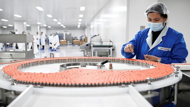 A staff member at a factory built to produce a Covid-19 coronavirus vaccine at Sinovac in Beijing. Picture: Wang Zhao/AFP