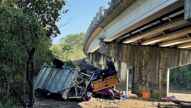 A vehicle and trailer has come off a bridge and rolled down a river bank south of Mackay. Photo: Janessa Ekert