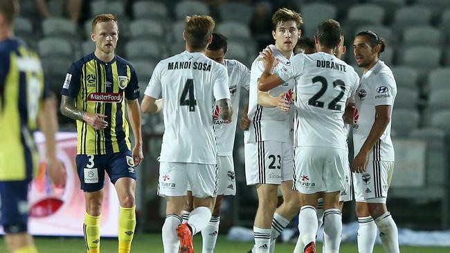 Wellington Phoenix players celebrate a goal scored by Roy Krishna.