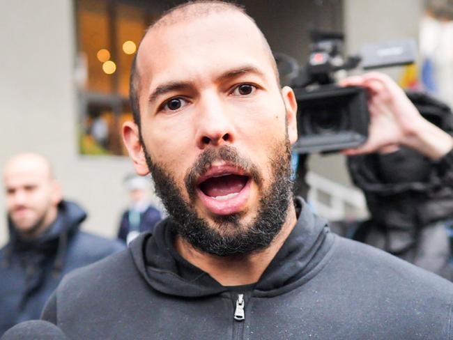 British-US former professional kickboxer and controversial influencer Andrew Tate talks to media as he leaves Romania's anti-organized crime and terrorism directorate (DIICOT) in Bucharest, Romania on January 25, 2023. (Photo by MIHAI BARBU / AFP)