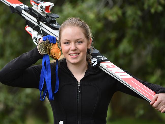 Lily Tomkinson shows off her medals.