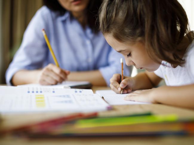 Mother helping daughter with homework