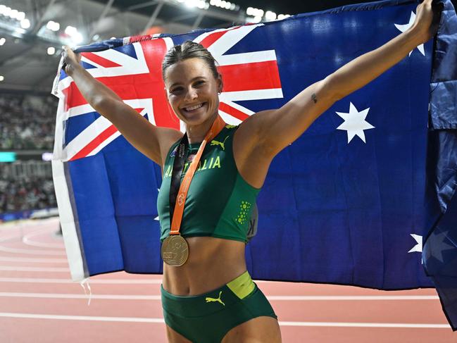 First-placed Australia's Nina Kennedy celebrates as she shares the gold medal with USA's Katie Moon after recording the same height in the women's pole vault final during the World Athletics Championships at the National Athletics Centre in Budapest on August 23, 2023. (Photo by ANDREJ ISAKOVIC / AFP)