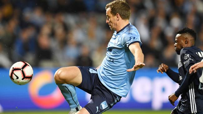Alex Wilkinson challenges for possession during the semi-final against Melbourne Victory on Sunday. Picture: AAP