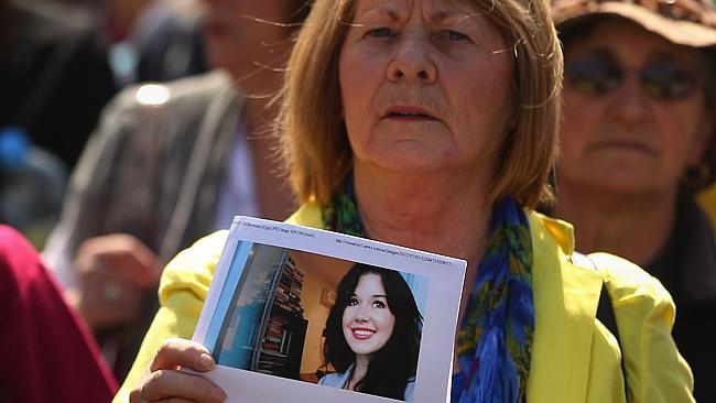 A woman holds a photograph of Jill Meagher during the march.