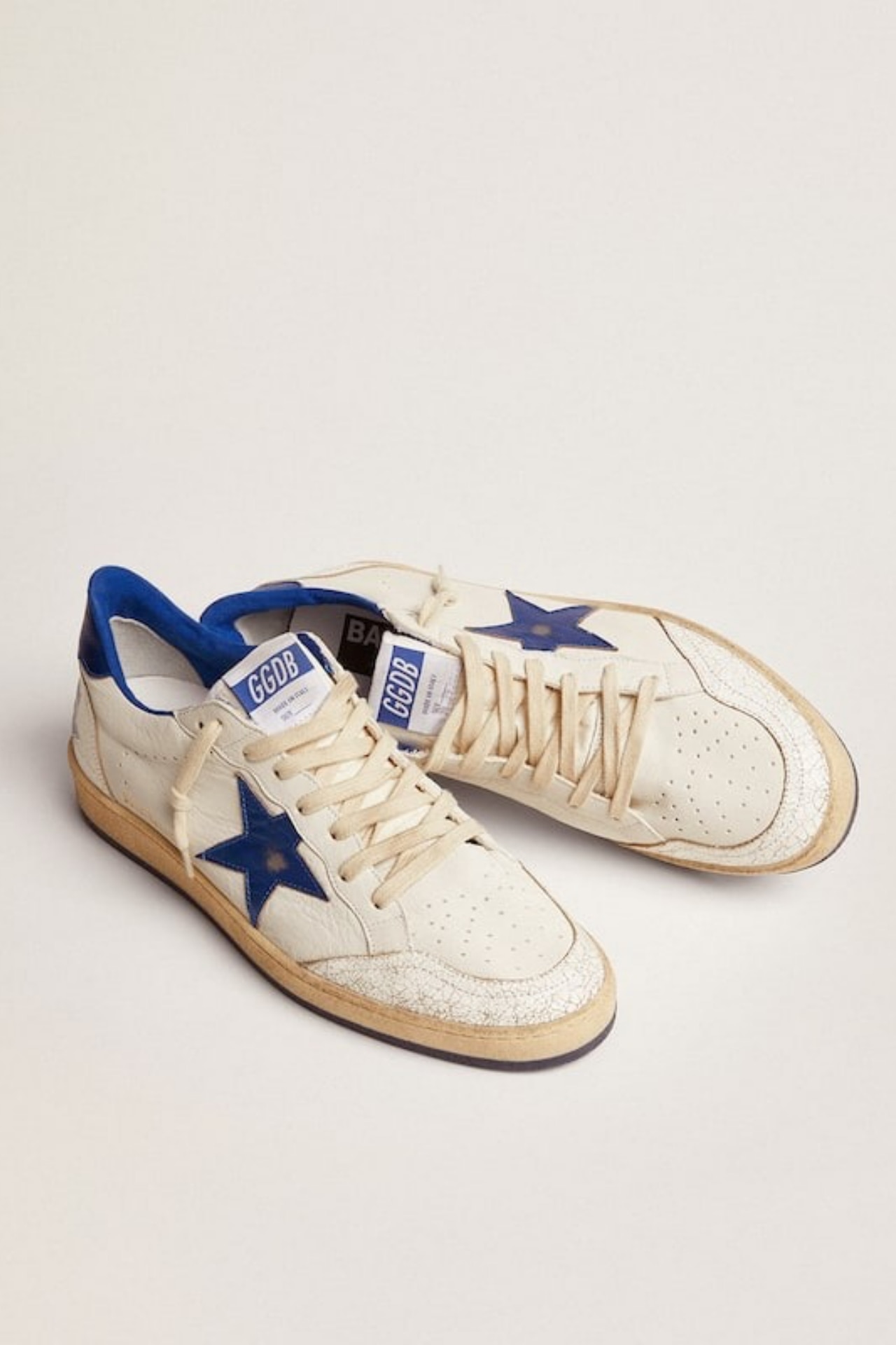 <h3><strong><a href="https://www.farfetch.com/au/shopping/women/golden-goose-deluxe-brand/items.aspx" target="_blank" rel="noopener">Golden Goose</a></strong></h3><p><strong>Ball star low-top sneakers</strong></p><p>This &rsquo;90s-inspired sneaker from Golden Goose features the label&rsquo;s intentional, slight scuffing detail along the rubber sole, and a blue leather star on the side.</p><p><strong>Material:</strong> Leather | <strong>Colour range:</strong> White and blue | <strong>Type:</strong> Low-top sneaker | <strong>Delivery:</strong> Free shipping over $300</p><p class="button-common"><a title="SHOP NOW FOR $635" href="https://www.farfetch.com/au/shopping/women/golden-goose-ball-star-low-top-sneakers-item-21390618.aspx" target="_blank" data-cta="SHOP NOW FOR $635" data-editable="true">SHOP NOW FOR $635</a></p>