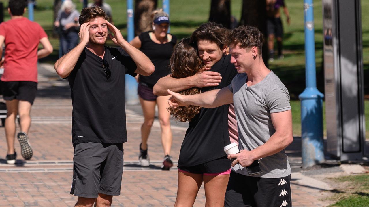 People hugging along the promenade at Coogee Beach in April. Picture: James Gourley