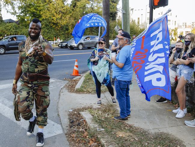 A Mr T impersonator walks past Trump supporters outside the debate venue. Picture: Angus Mordant for News Corp Australia