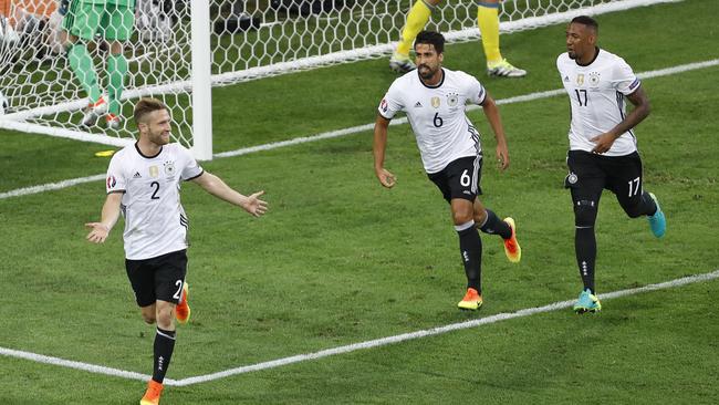 Germany's Shkodran Mustafi, left, celebrates after scoring the opening goal.