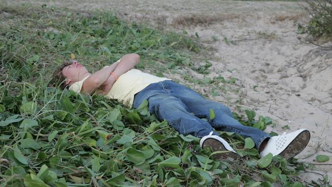 A New Years eve party goer sleeping it off at Mooloolaba Beach on New Year’s Day in 2007. Picture: David Thomas