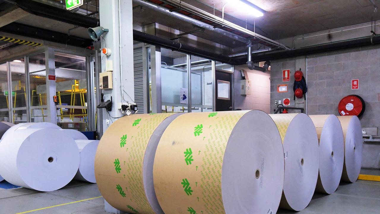 Reels of paper are seen inside the printing room at the NT News during the printing process. Pictures: KERI MEGELUS