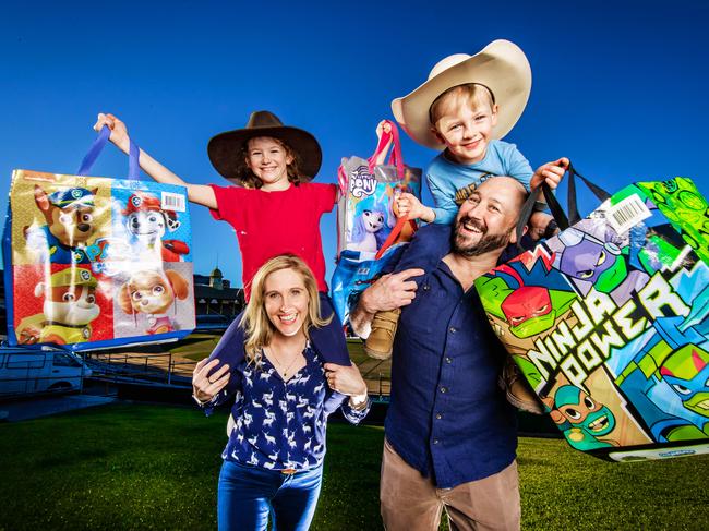 Ekka Tickets 2023.Tina and Tony White with their kids Lincoln, 4 and Felicity, 8 with showbags ahead of the Ekka.Picture: Nigel Hallett