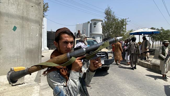 TA Taliban fighter holds a rocket propelled grenade as he stands guard with others at an entrance gate outside the Interior Ministry in Kabul on August 17. Picture: AFP