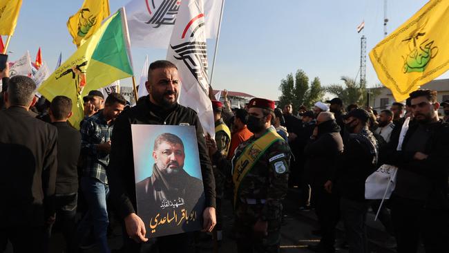 A man carries a portrait of Abu Baqir al-Saadi, who was killed in a US strike in Baghdad. Picture: AFP.