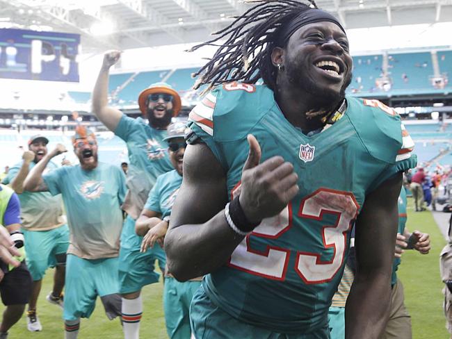 FILE - In this Oct. 23, 2016, file photo, Miami Dolphins running back Jay Ajayi is congratulated as he leaves the field at the end of an NFL football game against the Buffalo Bills in Miami Gardens, Fla. Ajayi has had three 200-yard games this season, and is eager to show what he can do in the playoffs. (AP Photo/Lynne Sladky)