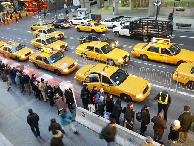 Morning rush hour commuters line up for cabs outside Grand Central Station in New York City. Picture: AP Photo/Mary Altaffer