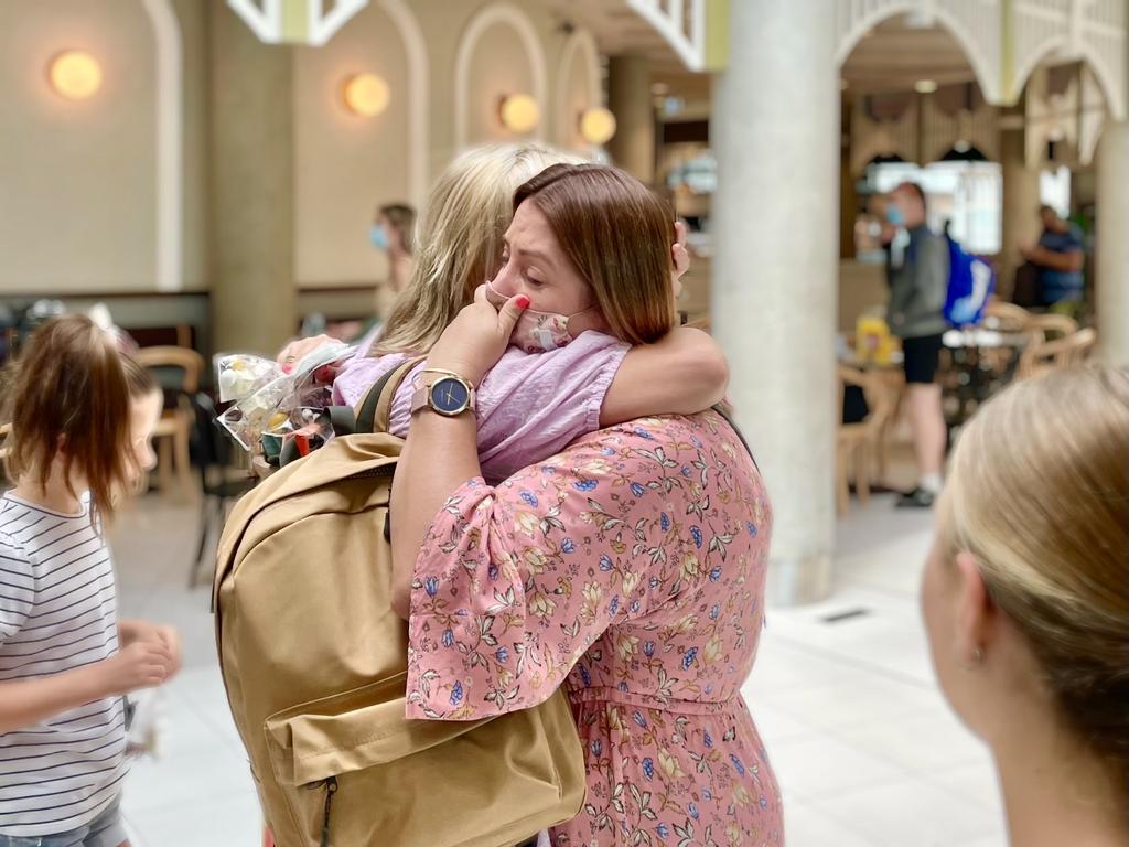 Sisters Stephanie Truscott, from Wollongong, and Vanessa Rasmussen, from Brisbane, embrace at the airport. Photo: Felicity Ripper