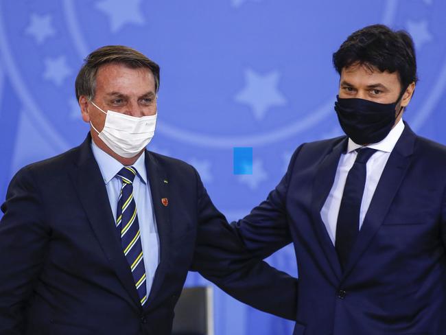 Brazilian President Jair Bolsonaro, left, congratulates his newly appointed communications minister, Fabio Faria, at the presidential office in Brasilia.