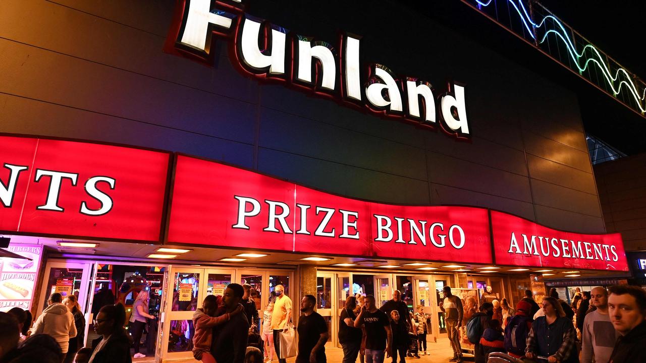 People walk past an amusement arcade in Blackpool, north west England. Picture: PAUL ELLIS / AFP