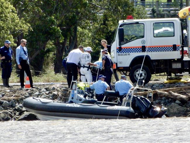 Police divers recover one of the bodies from the submerged car in the Tweed River following yesterday's tragedy. Picture: Nathan Edwards